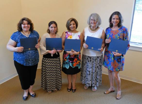 Participants from the most recent HOW graduating class at Project Self-Sufficiency display their certificates of achievement.