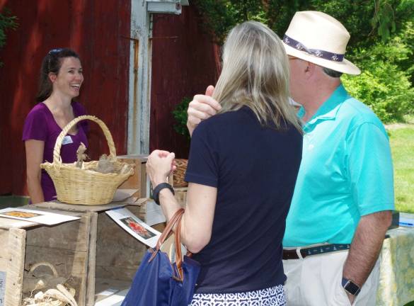 Shown at left, event coordinator Quill Teal-Sullivan greets visitors to Meadowburn Farm.
