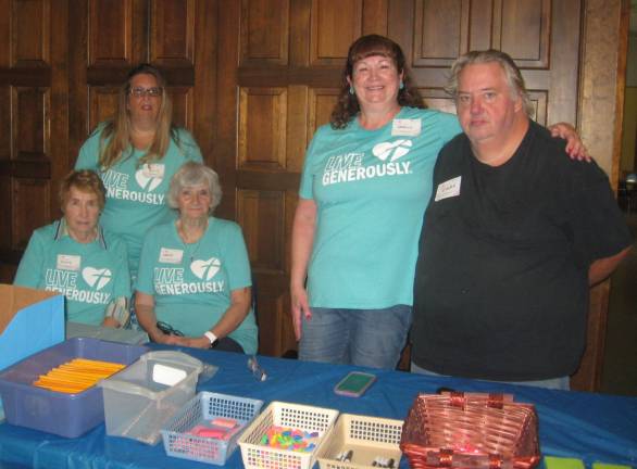 From left, Church volunteers, Nancy Malone, Carrie Fairhurst, Carole LaValle, Debbie Lennon and Gary Conklin are ready to distribute school supplies for the 2018-2019 school year.