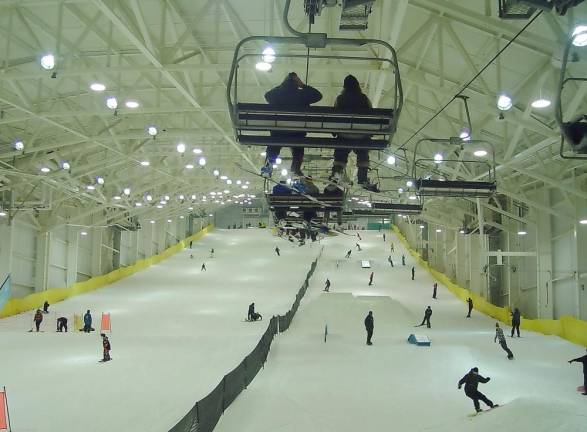 Joe Hession turns on the snow guns at his new, indoor ski resort The chairlift suspended from the roof of BIG Snow carries skiers and riders to the top of the slope. (Photo by Dr. John T. Whiting)