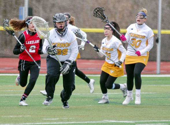 Lakeland defeats Vernon in girls lacrosse Vernon goalkeeper Emily Rhoades carries the ball with her crosse.