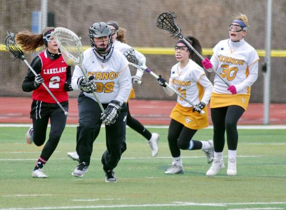 Vernon goalkeeper Emily Rhoades carries the ball with her crosse.