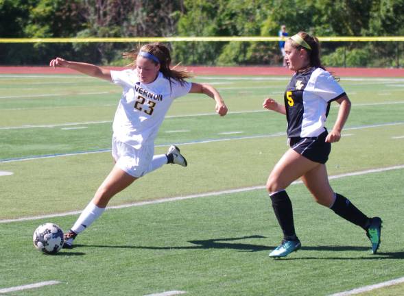 Vernon's Tea Brich is about to kick the ball while shadowed by West Milford's Natalie Hamblin late in the game. West Milford High School (Passaic County, N.J.) defeated Vernon Township High School in girls varsity soccer on Saturday, September 23, 2017. The final score was 2-0. The game took place at Vernon Township High School in Glenwood, New Jersey.