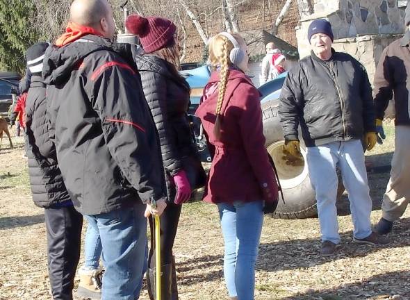 Patrons wait for the hayride to the field armed with saws.