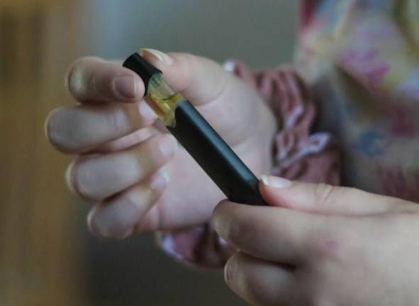 Loading cartridge into vaping device.