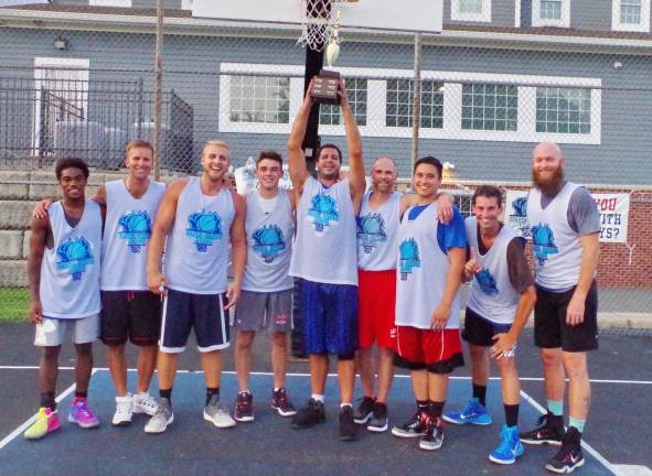 Team Smalley wins summer basketball league Team Smalley captain John Smalley raises the Sparta Summer Basketball League championship trophy high during a team portrait after their victory over Team Tobin.
