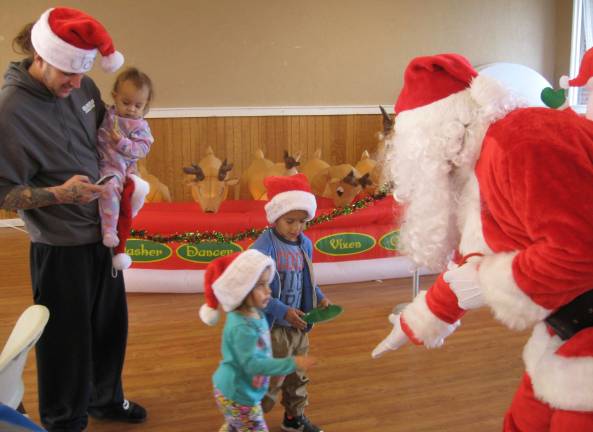 Barry Lakes Holiday Party Santa meets his admirers, the Fruit family.