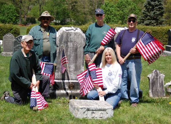 Members of the American Legion Post 423 are shown preparing for Memorial Day, 2014. Service Officer Joe Mikowski , Past Commander Dr. Clifford Williams, Larry Parr, Ladies Auxiliary member Jackie Sorce and George Pyryt pause in their decorating of graves at the Oak Ridge Cemetery.
