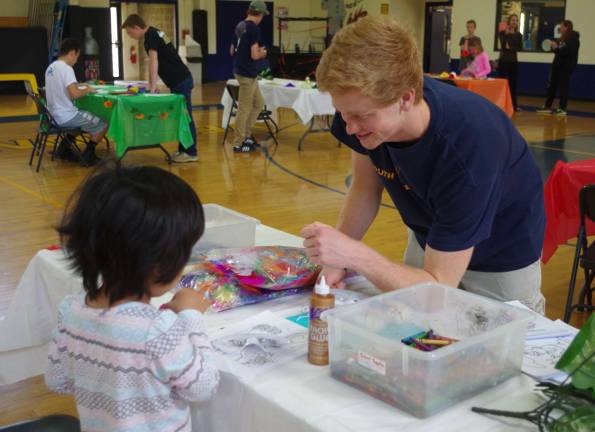 Vernon Township High School Junior and PAL Youth Leadership President Christopher Ploch, 17, helped the youngsters create artwork during the annual Vernon PAL Youth Leadership Cultural Day.
