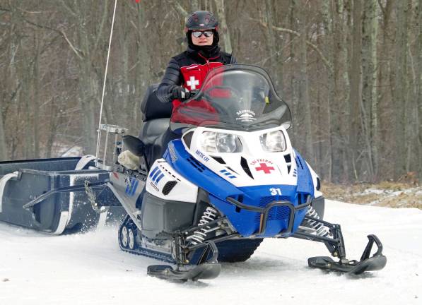 State and local firefighters race for burn center Vernon resident Susanne Ebling, the director of the Mountain Creek Ski Patrol, spent the day on a snowmobile bringing the fire hoses used in the race back to the starting gate.