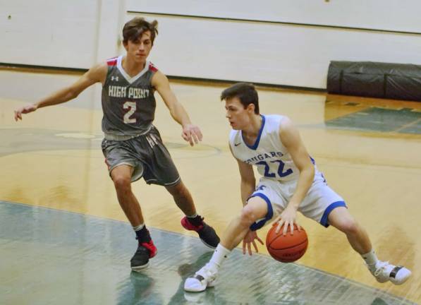Kittatinny's Hunter Rossi dribbles the ball between his legs while covered by High Point's Donald Bassani in the first quarter. Rossi scored 5 points.
