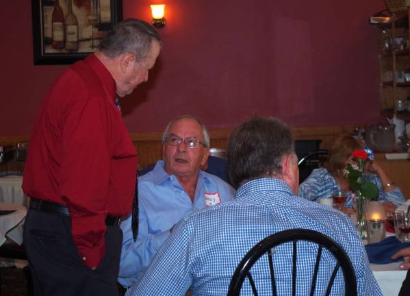 At left, former Police Chief Ken Johnson went from table to table to greet old friends and coworkers.