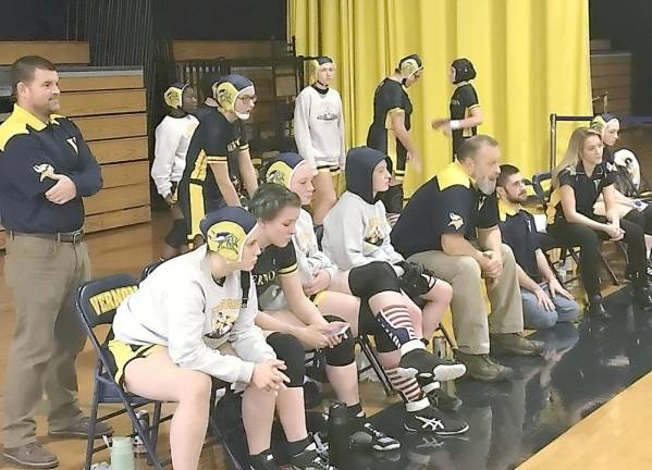 The Vernon girls' wrestling team watches a match.