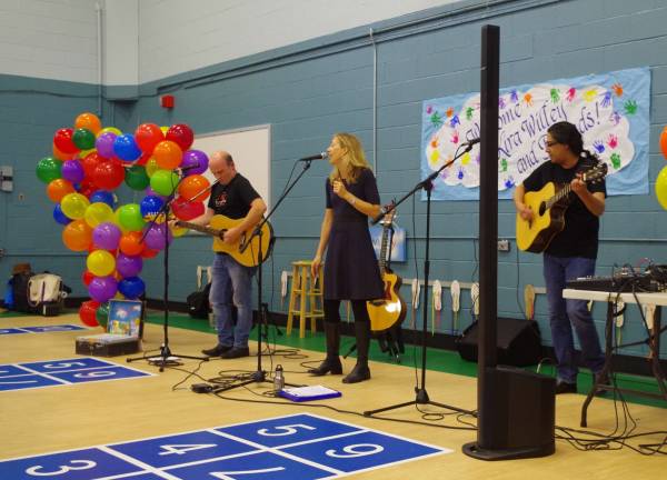 From the left are performers Leo McClusky of North Arlington, Kira Willey of Bethlehem, Pa., and Zak Rizvi of Lake Hopatcong as they introduce the young students to musical yoga.