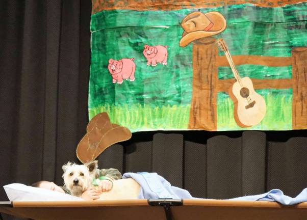 High Point hosts Kickin' Country "Scruffy" peaks out as Ryan relaxes on the cot.