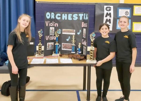 Reese, Emily and Lily shared the songs that they will play at the Holiday concert and even played an instrument to demo what they have learned.