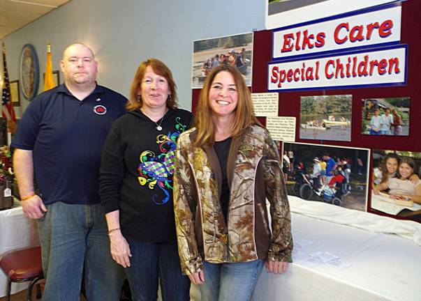 Welcoming visitors at the door and sharing information about &quot;Elks Care Special Children&quot; were Northwest District Chairman Wayne McDonnell, and Sussex Elks organizers Carrie Meister and Patty Green.