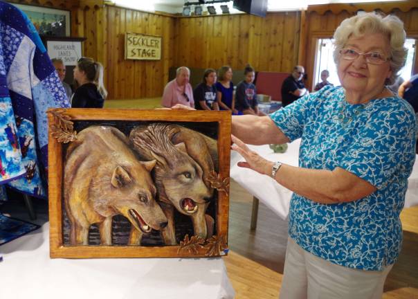Anna Thomsen holds the Best Three-Dimensional wolf relief, created by her son John Thomsen who was not present to receive his award.