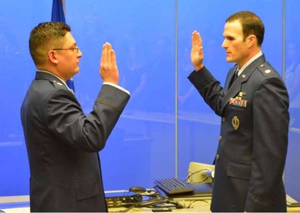 Vernon native promoted to major Matthew Shull, right, is sworn in as a Major in the U.S. Air Force.