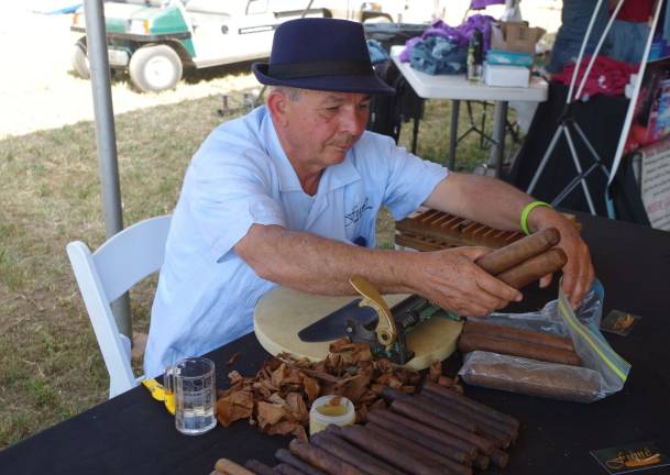 Dominican Republic native Victor Cruz spent the afternoon hand-rolling large cigars that were in high demand. He and his son Nelson, are with the Fum&#x2021;&#xa9; Cigar Shop &amp; Lounge of Montclair.