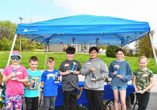 Winners of the Fishing Derby pose with their awards.