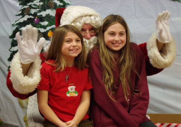 Arriving in Barry Lakes just this year are Cassidy Baker, 7, and her sister Emily, 8, who enjoyed their first Christmas party in the lake community.