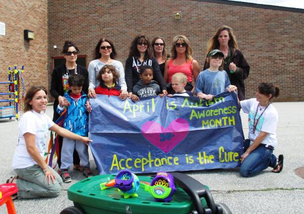 Photo by Viktoria-Leigh Wagner Clifton E. Lawrence school students hold up a sign that reads 'Acceptance is the Cure.'