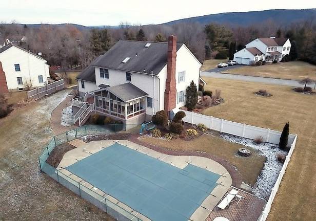 Spacious center hall colonial has in-ground pool