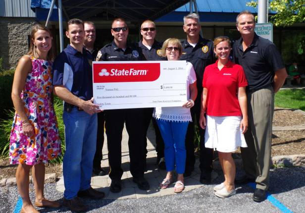 A $5,600 grant from State Farm Insurance was presented to the Vernon PAL. From left are teacher Lisa Haw, Det. Sgt. Jason Haw, Chief Randy Mills, Ptl. Matt Hackett, Sgt. David Dehardt, PAL assistant director Jeanne Buffalino, Lt. Keith Kimkowski, and State Farm employees Jen Young and Tom Ziegenbalg.