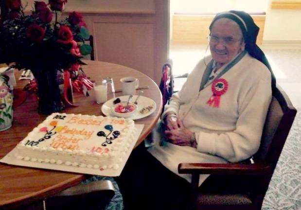 Former St. Clare's head turns 102 Sr. Mary Urban Harrer is shown with a cake marking her 102nd birthday.