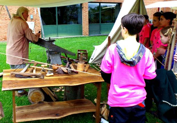 Colonial Day brings lessons and fun Keith Hopler of Beemerville shared his knowledge about Early American woodworking with the kids. His dog "Patches" was also popular with the children.