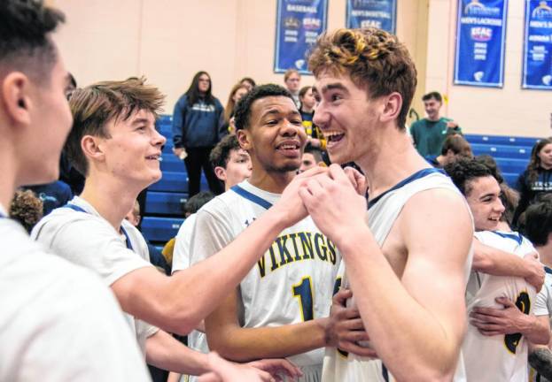 Senior Ben Jurewicz, center, is all smiles after the Vikings defeat Hunterdon Central, 47-42, in the H/W/S Tournament final Friday, Feb. 16 at Centenary University in Hackettstown.