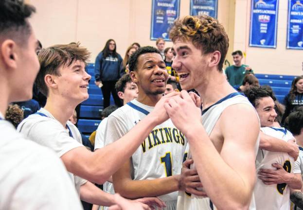 Senior Ben Jurewicz, center, is all smiles after the Vikings defeat Hunterdon Central, 47-42, in the H/W/S Tournament final Friday, Feb. 16 at Centenary University in Hackettstown.