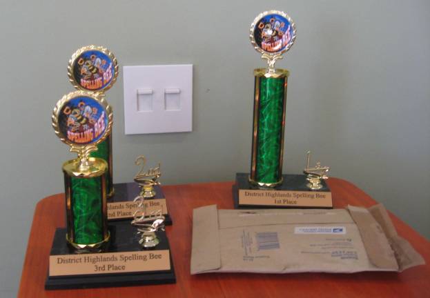 Trophies await three spelling experts at the Highlands District Spelling Bee sponsored by the NJ State Federation of Women&#xfe;&#xc4;&#xf4;s Clubs.