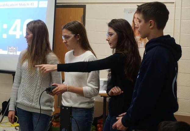 High Point hosts robotics competition Team E.L.K. discusses strategy as a competitor's robot tries to block their robot. From left, Lauren Kaitlyn, and Elodie are shown.