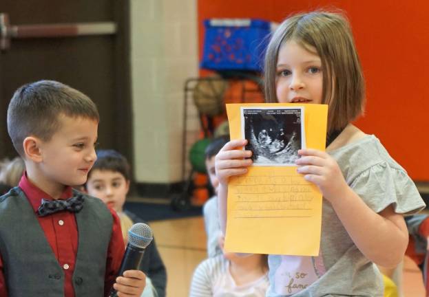 Cedar Mountain students show their talents From right, Carli shows her sibling's sonogram, as Frankie looks on left.