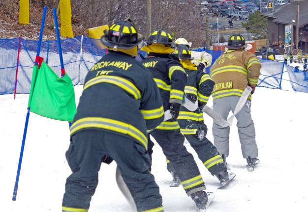 State and local firefighters race for burn center Members of the Rockaway Fire Department approach the finish line.