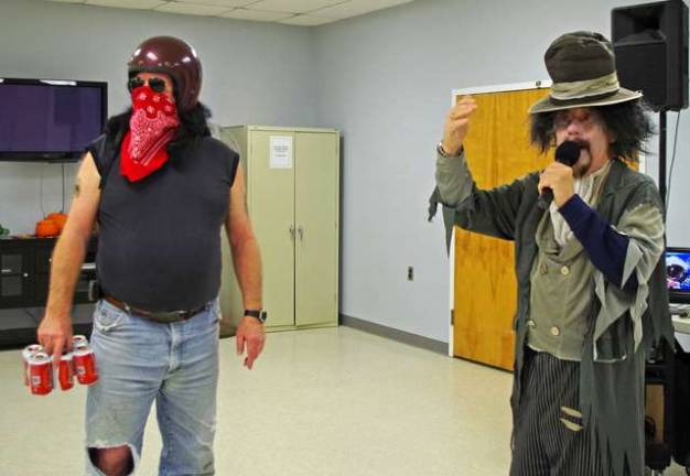Highland Lakes resident and outlaw biker Phil Badu and zombie DJ Allan Boles of Lake Stockholm call the costumed seniors out onto the dance floor.