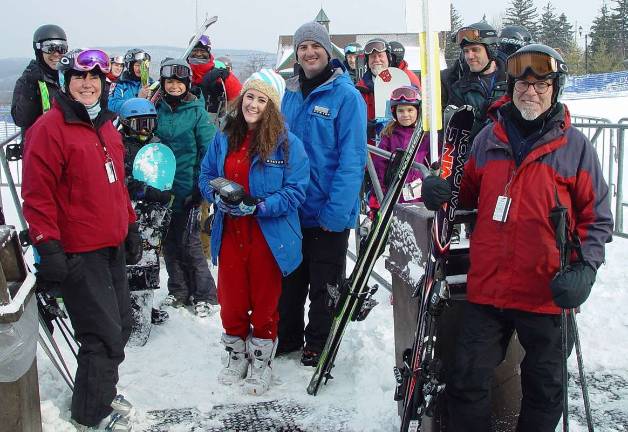 Adaptive ski committee tests Mountain Creek lifts Skiers wait for Lift Operator Laurie form Vernon to open the Cabriolet lift at Mountain Creek.