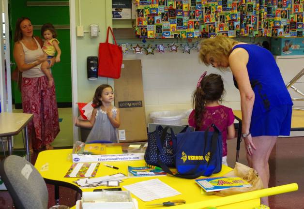 At right, kindergarten teacher Christine Bross welcomed new students and their families.