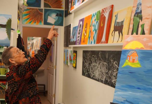 PHOTOS BY VERA OLINSKI Hardyston Mayor Leslie Hamilton admires the Painted Grape studio paintings.