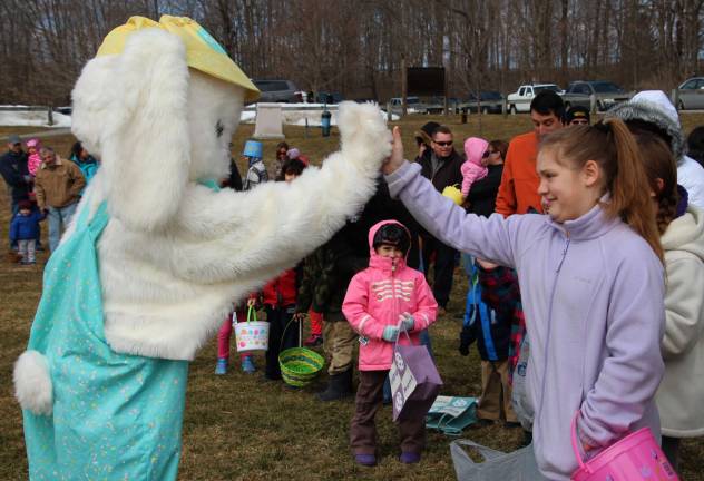 Mackenzie Baker of Wantage give the Easter Bunny a high-five.