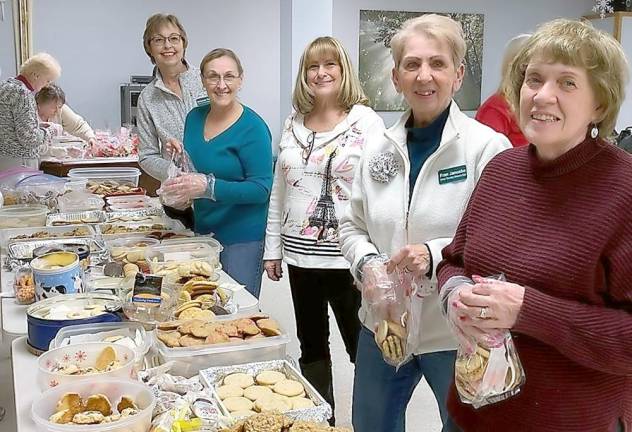 More than 2,000 cookies baked by members of the Vernon Township Woman’s Club are bagged by, from left, Debbie Tiene, Marie Flores, Sandy Stouthammer, Fran Janusko and Judy Filippini. In the background, Ann Augusta and Valerie Seufert tie the bags closed and pack them for delivery.