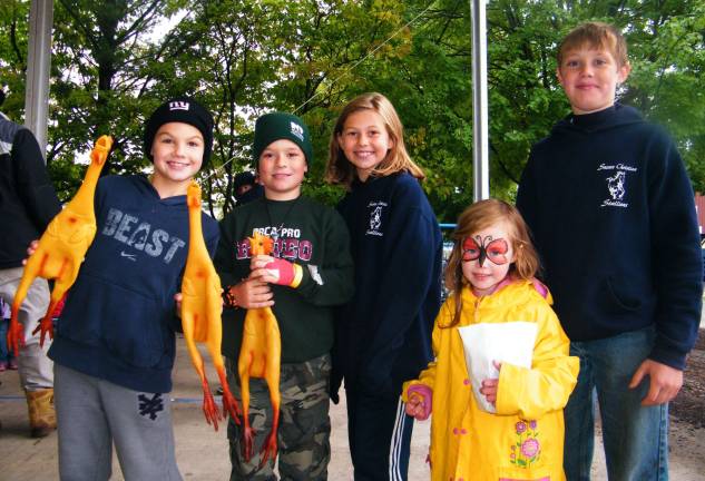 Wantage residents Andrew Noonan, 9, Garrett Coerts, 9, Dallas Walther, 9, Noah Drew, 10, and Sonja Drew, 4, prepare for the kids' mini-tractor pull.