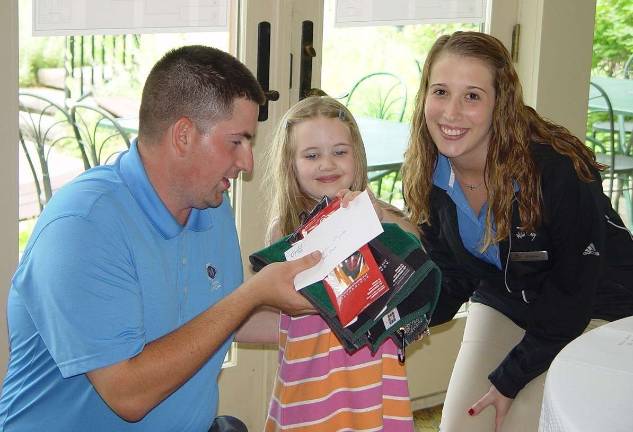 Crystal Springs hosts Father's Day golf Hazel Chernosky,5, wins the K þÄì 4 Division with Crystal Springs Event Coordinator Rob Tomson and Stephanie Siglin.