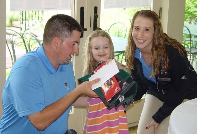 Hazel Chernosky,5, wins the K &#xfe;&#xc4;&#xec; 4 Division with Crystal Springs Event Coordinator Rob Tomson and Stephanie Siglin.