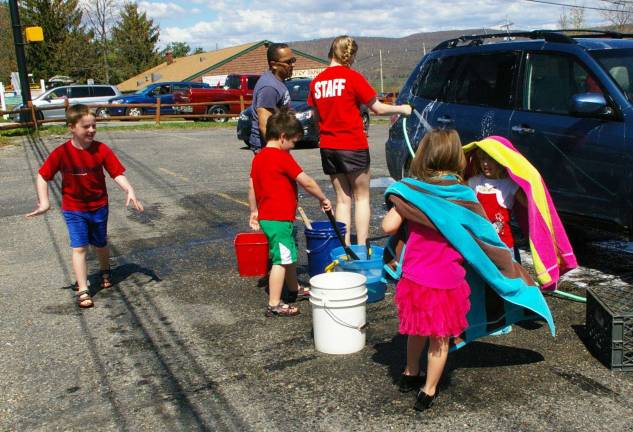 Group members wash cars.