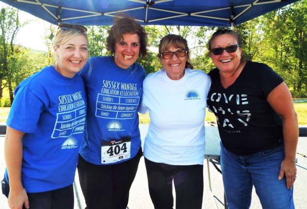 PHOTOS BY VIKTORIA-LEIGH WAGNER Sussex-Wantage Education Association volunteers present at the Wantage Recreation Commission's 12th Annual Family Run-Walk at Woodbourne Park smile at the team effort Saturday, Sept. 17th.