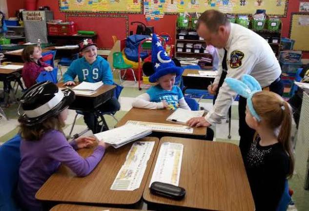 Sussex County Sheriff Michael Strada works with Cedar Mountain Primary School students.
