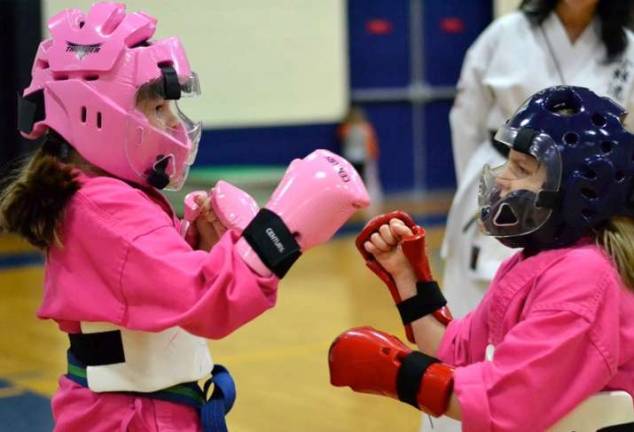 Lauren Fattorusso and Caterina Dorsey preparing for sparring competition.